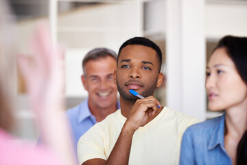 Man, listening and thinking with crowd in office for presentation, training or workshop at media company. Person, attention and audience with diversity at meeting in boardroom at creative agency