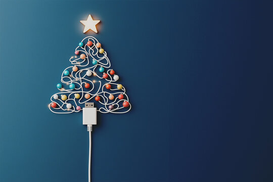 Modern Christmas tree made of white USB cable with colorful ornaments and star on top, plugged in on blue background. design/web/media