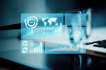 Digital business data interface with graphs and charts over blurred laptop background, concept of technology and analytics.