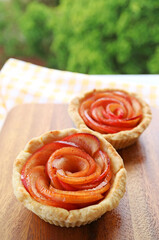 Closeup of Apple Rose Tartlets with Blurry Green Foliage in the Backdrop