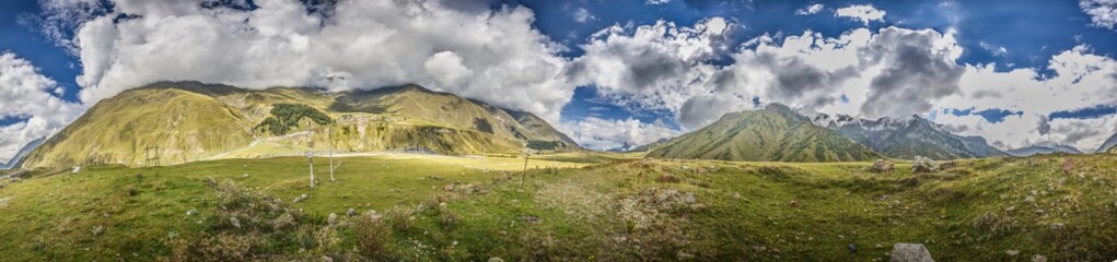 Scenic view of the Cross Pass in Georgia, showcasing lush green mountains and a winding valley