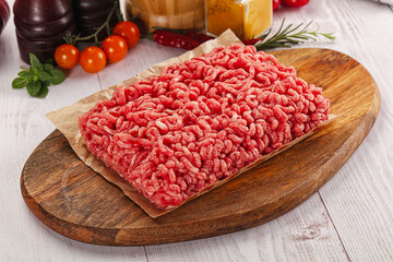 Raw minced beef meat over board