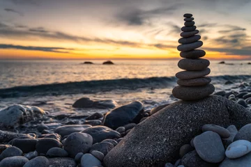 Fotobehang Zen Stenen Sunset on the beach. Summer holidays on Corfu, Greece. Stack of stones on beach  © Piotr