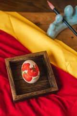 Eggs with auspicious patterns painted on them are placed in a wooden box, which are a symbol of the Chinese folk customs and festivities.