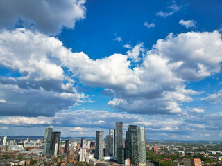 Obraz premium Aerial View of Greater Manchester City Centre and Tall Buildings During Golden Hour of Sunset. England UK. May 5th, 2024, High Angle Footage Was Captured with Drone's Camera