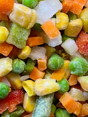 Multicolored cubes of frozen vegetables. Background. Texture