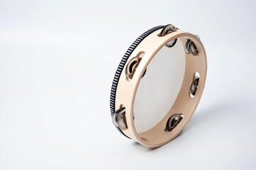 Tambourine is a percussion musical instrument, shot on a white background.