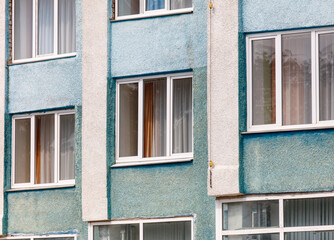 A blue and white building with many windows