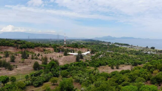 Aerial video of green plains with islands and mountains in the background