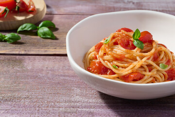 Spaghetti with tomato sauce and basil. Typical dish of Italian tradition.