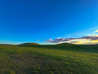 People who are relaxing in a public park with hills  in Auckland, New Zealand.
