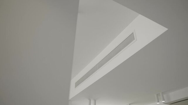 Supply ventilation system on white ceiling. Concept for modern ventilation technology, climate comfort control Interiors and solutions. Slow motion video with copy space.