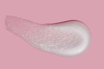 White cosmetic cream texture, skincare lotion swatch on pink background. Face creme, body moisturizer, hair conditioner smear smudge stroke. Creamy beauty product closeup