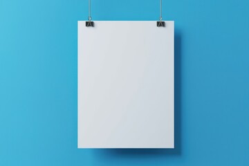 A blank sheet of paper is suspended against a vibrant blue wall, ideal for presentations or creative displays.