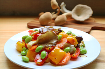 Plate of colorful grilled vegetable salad with freshly harvested mushrooms