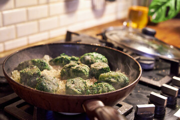 a man fries vegetables in a skillet on the stove