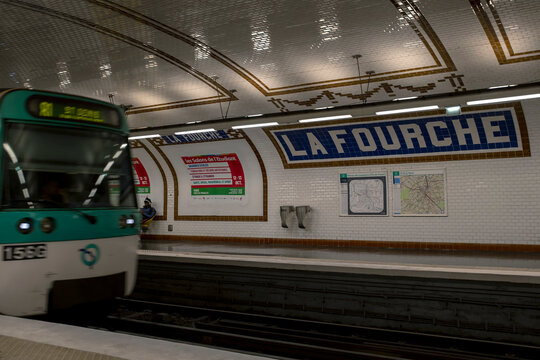 The train arrives at the La Fourche stop on line 13 of the Paris Metro, France