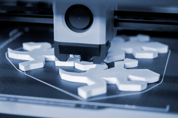 Process of printing on 3D printer. 3D printer creating model from molten plastic close-up. Molten plastic flowing of extruder and forming three-dimensional object white color. Additive technologies