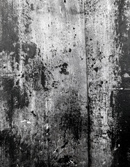 Monochromatic Grunge: A captivating abstract of weathered textures, showcasing the beauty of decay and time's passage on a dark surface.