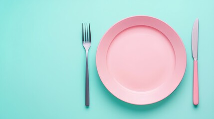 Elegant Dinner Setting with Pink Plate, Fork, and Knife on a Turquoise Background - Minimalist Dining Concept