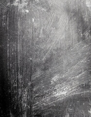 Obraz premium Abstract grayscale texture; strokes of white and grey on dark background. A captivating study in contrasts and shades.