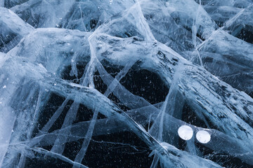 Beautiful natural blue ice texture of surface of frozen Baikal Lake in cold winter day. Nature...