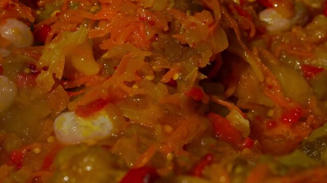 A traditional Romanian cooking moment where tomato puree is poured into a cauldron over a wood fire. This rustic outdoor scene captures the making of authentic zacusca, a flavorful spread
