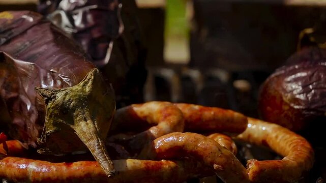 A rustic outdoor scene of vegetables grilling over a wood fire, an essential step in making traditional Romanian zacusca. The fire-roasted vegetables bring out deep, smoky flavors.