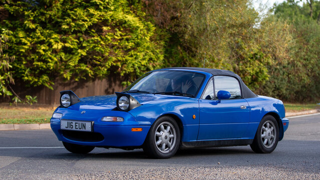 1992 blue Mazda Miata MX5 with pop up headlights