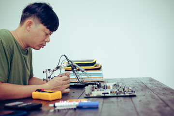 Technicians meticulously repair electronic components to turn them into precious gold. This process emphasizes advanced technical skills.