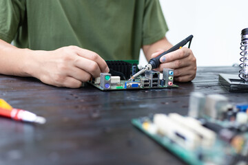 Technicians meticulously repair electronic components to turn them into precious gold. This process emphasizes advanced technical skills.