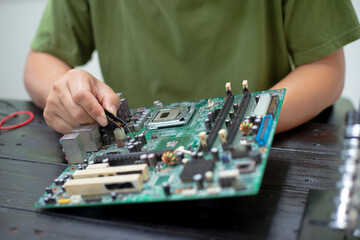 Technicians meticulously repair electronic components to turn them into precious gold. This process...