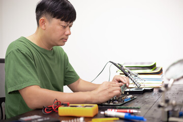 Technicians meticulously repair electronic components to turn them into precious gold. This process...