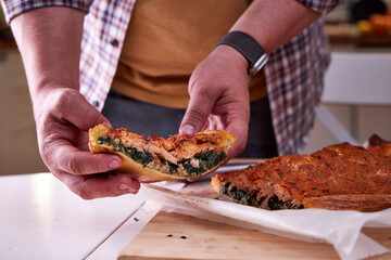 a piece of fish pie in the chef's hand. Close-up