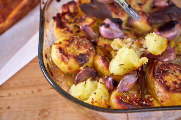 The cook is tasting a baked potato. Close-up