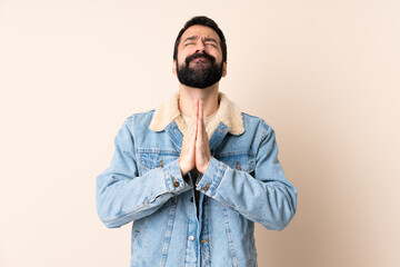 Fototapeta premium Caucasian man with beard over isolated background keeps palm together. Person asks for something