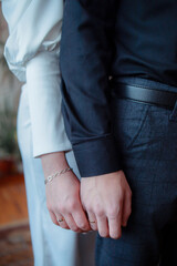 Wedding bouquet in the hands of the bride at the ceremony. Touching the hands of the bride and groom. Hugs of the newlyweds. Future married couple. The tenderness and beauty of the wedding ceremony.