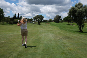 green golf course in a sunny day 