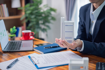 Real estate agent handed key to client, finalizing purchase and sale of property, marking successful home investment. agent, estate, property, real, key, home, house, investment, purchase, buy.