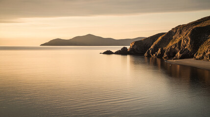 Golden sunset over peaceful coastal landscape with gentle waves and distant mountains