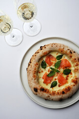 Champagne glasses and pizza on restaurant table, close-up