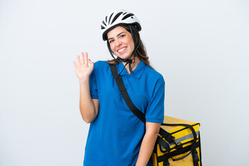 Young delivery woman with thermal backpack isolated on white background saluting with hand with happy expression