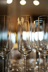 Empty wine glasses in a row in bar restaurant, close-up