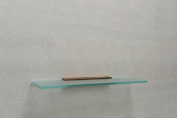 Glass shelves on bathroom wall