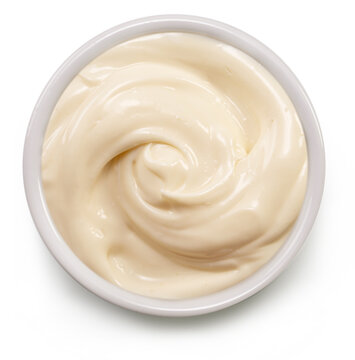 Homemade mayonnaise in white bowl on white background, top view. File contains clipping path.