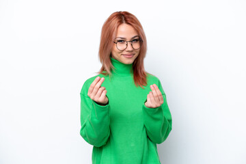 Fototapeta premium Young Russian girl isolated on white background making money gesture