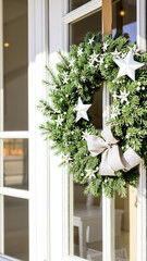 Fototapeta premium festive evergreen wreath with silver stars adorns a white door