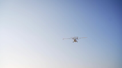 Small airplane flying in a clear blue sky