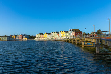 Row of colorful modern houses  and bridge