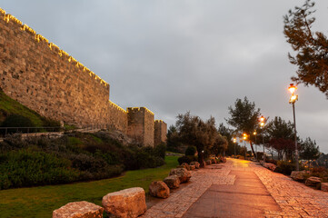 Section of the ramparts and walls of the Old City of Jerusalem, illuminated by decorative lights on Mt. Zion. © Yehoshua Halevi